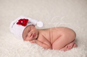 Baby sleeping with white knitted red rose hat during these cold days in Chicago.