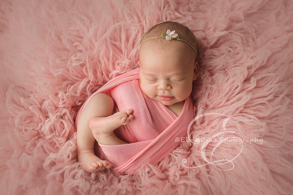 Chicago-Newborn-Photographer-Elvie-girl-pink-fur-wrapped-smile
